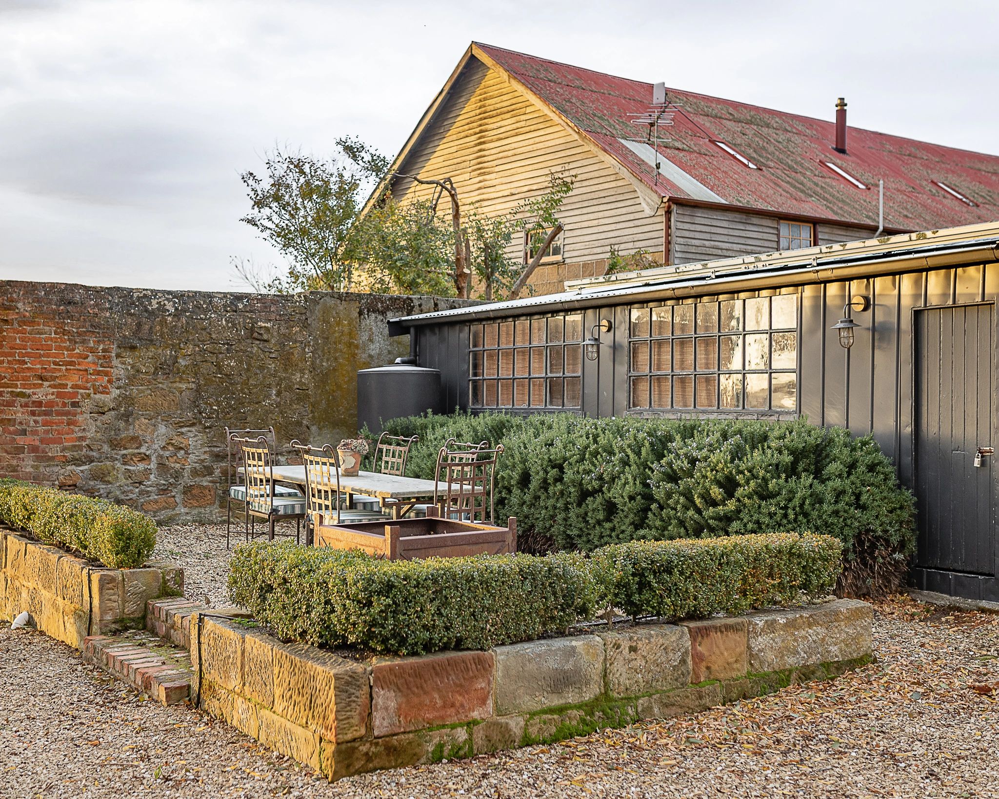 Raffah House courtyard with barn and garden beds
