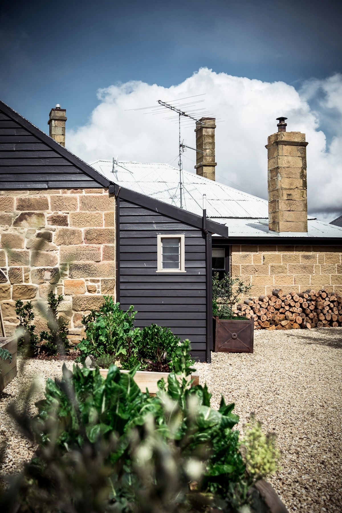 Raffah House stone cottage with dramatic blue sky